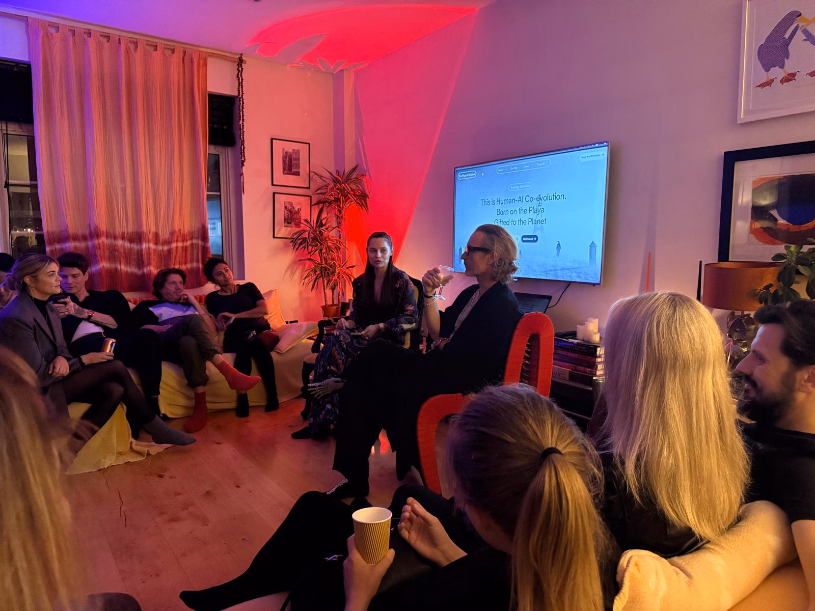 Community members seated in a salon-style gathering